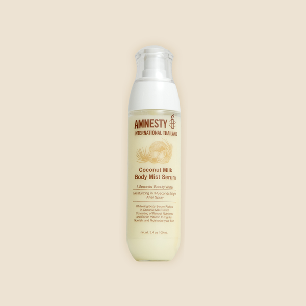 Amnesty International Coconut Milk Body Mist Serum bottle on a beige background